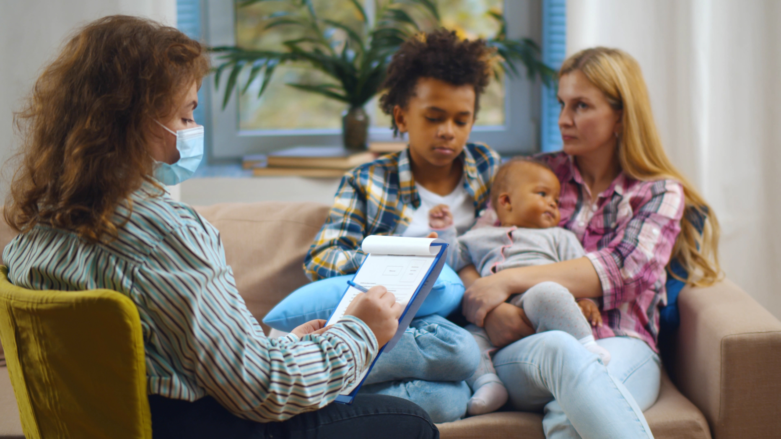 Social worker interviewing a mother about her two children.