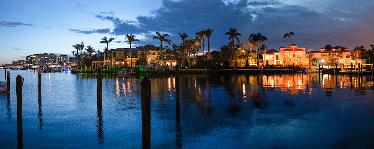 Lake Boca Raton and city skyline with reflections at sunset, panoramic view.